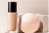 Foundation bottle and pressed powder compact in warm beige tones