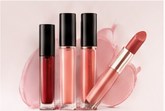 Three lip glosses and a lipstick in rose and berry tones